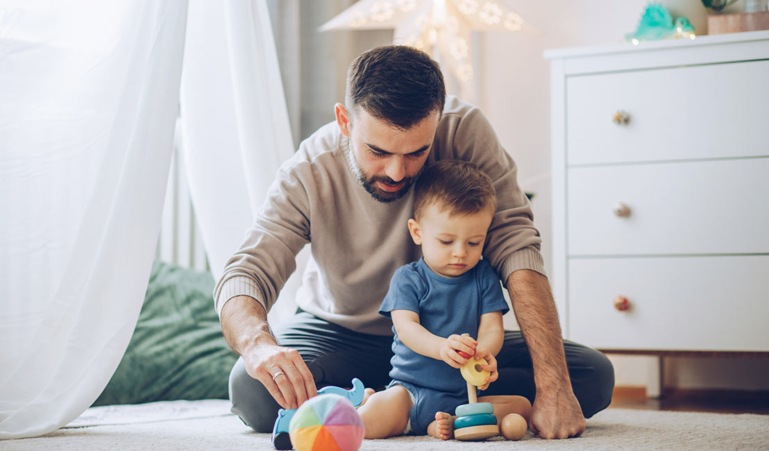 Father and toddler son enjoying comfortable home